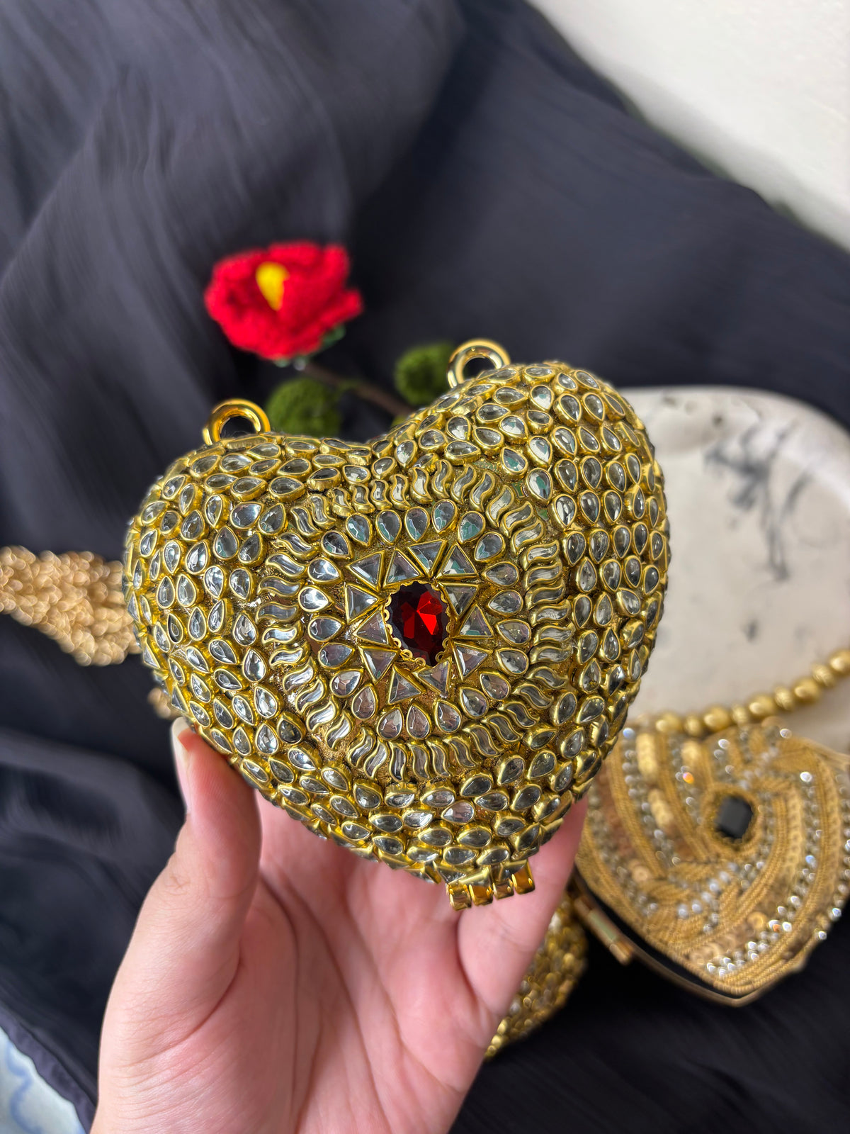 Heart Shaped Kundan Clutch With Maroon Stone